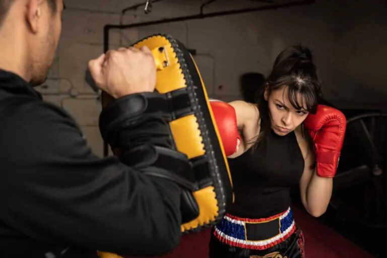 Woman practicing punches in a martial arts class