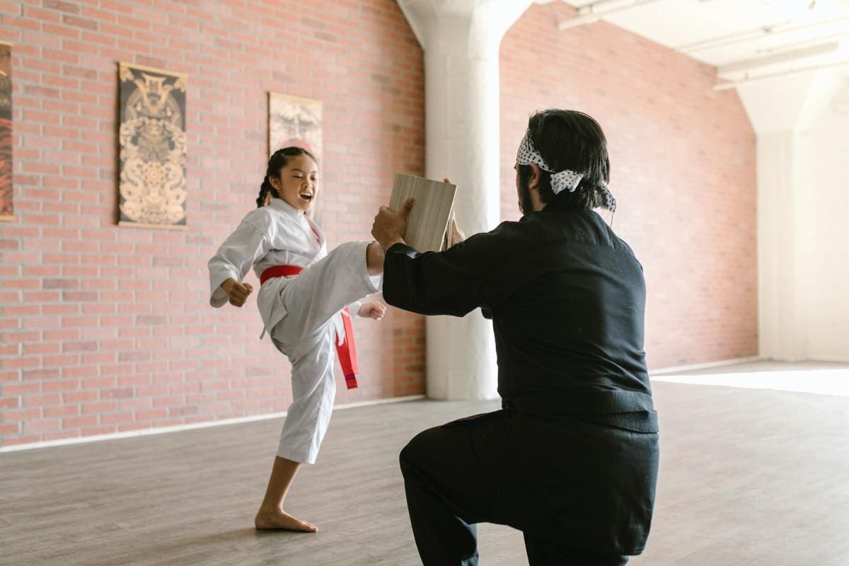 Kid practicing kicks in a martial arts class